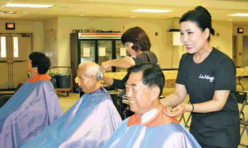 Hair stylists from a salon near Fairfax, Virginia, participate in a charity event Saturday to help the elderly in South Korea.