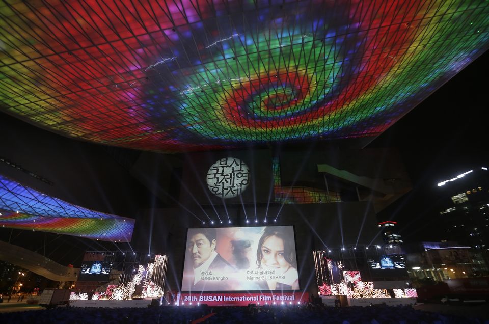 A screen shows Afghanistan actress Marina Golbahari, right, and South Korean actor Song Kang-ho on the eve of the opening ceremony of the Busan International Film Festival at Busan Cinema Center in Busan, South Korea. Wednesday, Sept. 30, 2015. Asia's largest movie festival kicks off Thursday at a time when the region's influence on the global movie industry is on the rise. (AP Photo/Ahn Young-joon)