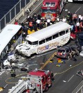 Emergency personnel work at the scene of a fatal collision involving a charter bus, center left, and a "Ride the Ducks" amphibious tour bus on the Aurora Bridge in Seattle on Thursday, Sept. 24, 2015. (Ken Lambert/The Seattle Times via AP)