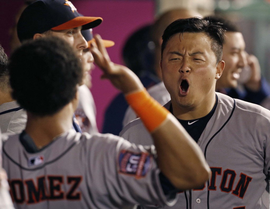 Houston Astros' Hank Conger is congratulated after hitting a solo home run in the seventh inning of a baseball game against the Los Angeles Angels in Anaheim, Calif., Saturday, Sept. 12, 2015. (AP Photo/Christine Cotter)