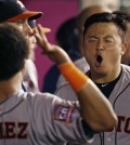 Houston Astros' Hank Conger is congratulated after hitting a solo home run in the seventh inning of a baseball game against the Los Angeles Angels in Anaheim, Calif., Saturday, Sept. 12, 2015. (AP Photo/Christine Cotter)