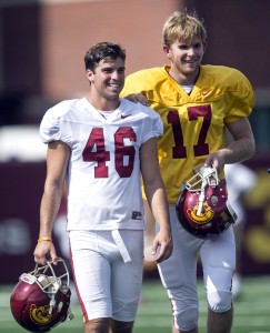 USC's Reid Budrovich, left, guides teammate Jake Olson, through the field during practice at Howard Jones Field in Los Angeles. Jake Olson, the blind long snapper from Orange Lutheran High, participated in his first practice as a member of the USC football team Tuesday, Sept. 15, 2015. (Ed Crisostomo/The Orange County Register via AP)