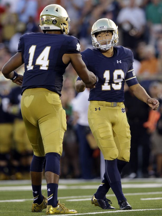 Notre Dame kicker Justin Yoon, right, celebrates with defensive back Shaun Crawford after scoring a field goal against Texas during the first half of an NCAA college football game Saturday, Sept. 5, 2015, in South Bend, Ind. Notre Dame won 38-3. (AP Photo/Nam Y. Huh)