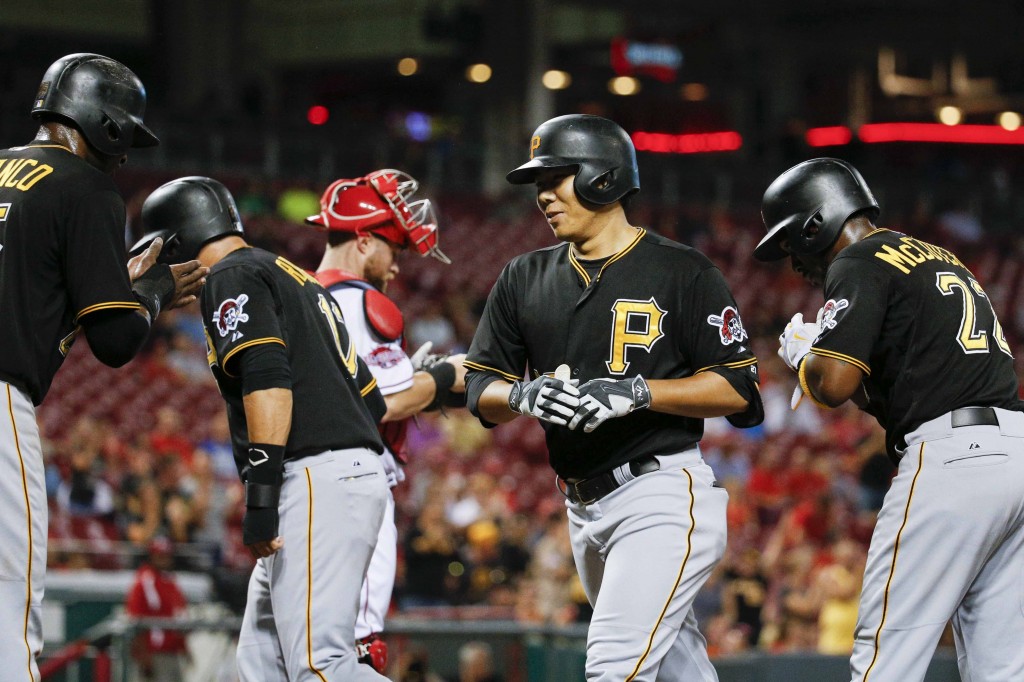 Pittsburgh Pirates' Kang Jung-ho, center right, runs to the dugout with Gregory Polanco, left, Aramis Ramirez, center left, and Andrew McCutchen, right, after hitting a grand slam off Cincinnati Reds starting pitcher Keyvius Sampson during the sixth inning of a baseball game, Wednesday, Sept. 9, 2015, in Cincinnati. (AP Photo/John Minchillo)