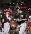 Pittsburgh Pirates' Kang Jung-ho, center right, runs to the dugout with Gregory Polanco, left, Aramis Ramirez, center left, and Andrew McCutchen, right, after hitting a grand slam off Cincinnati Reds starting pitcher Keyvius Sampson during the sixth inning of a baseball game, Wednesday, Sept. 9, 2015, in Cincinnati. (AP Photo/John Minchillo)