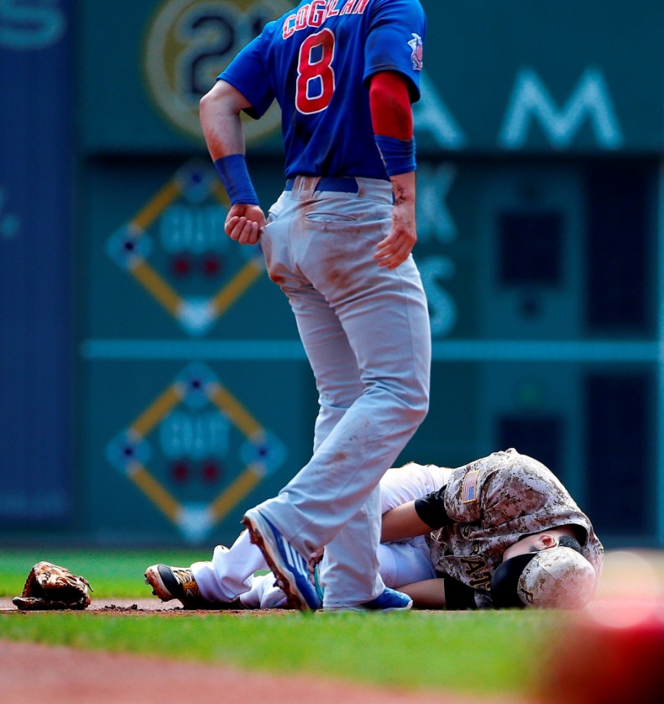 Pittsburgh Pirates' shortstop Jung Ho Kang holds his left knee after injuring it while turning a double play on Chicago Cubs' Chris Coghlan (8) in the first inning of a baseball game against the Chicago Cubs in Pittsburgh, Thursday, Sept. 17, 2015. Kang left the game. (AP Photo/Gene J. Puskar)
