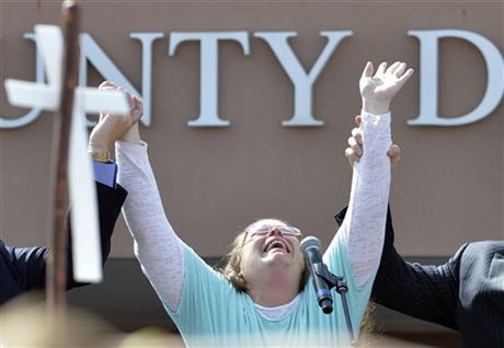 Rowan County Clerk Kim Davis cries out after being released from the Carter County Detention Center, Tuesday, Sept. 8, 2015, in Grayson, Ky. Davis, the Kentucky county clerk who was jailed for refusing to issue marriage licenses to gay couples, was released Tuesday after five days behind bars. (AP Photo/Timothy D. Easley)
