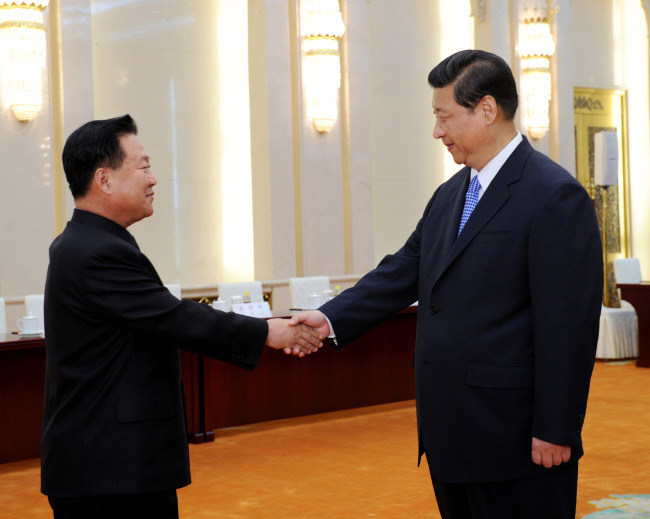 In this May 24, 2013, file photo released by China's Xinhua News Agency, North Korean Vice Marshal Choe Ryong Hae, left, is greeted by Chinese President Xi Jinping in Beijing when the top North Korean envoy delivered a letter from leader Kim Jong Un to Xi and told him Pyongyang would take steps to rejoin stalled six-nation nuclear disarmament talks. If North Korea launches a rocket into space or conducts a nuclear test in the coming weeks, marking the 70th anniversary of the founding of its ruling Workers Party on Oct. 10, 2015, as observers suspect it may, China is certain to respond angrily, and perhaps with an unprecedented level of economic punishment. (Rao Aimin/Xinhua News via AP)