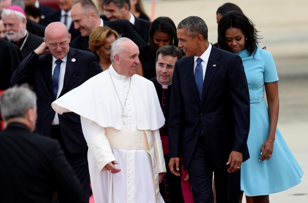 Pope Francis talks with President Barack Obama, accompanied by first lady Michelle Obama, after arriving at Andrews Air Force Base in Md., Tuesday, Sept. 22, 2015. The Pope is spending three days in Washington before heading to New York and Philadelphia. This is the Pope's first visit to the United States. (AP Photo/Susan Walsh)