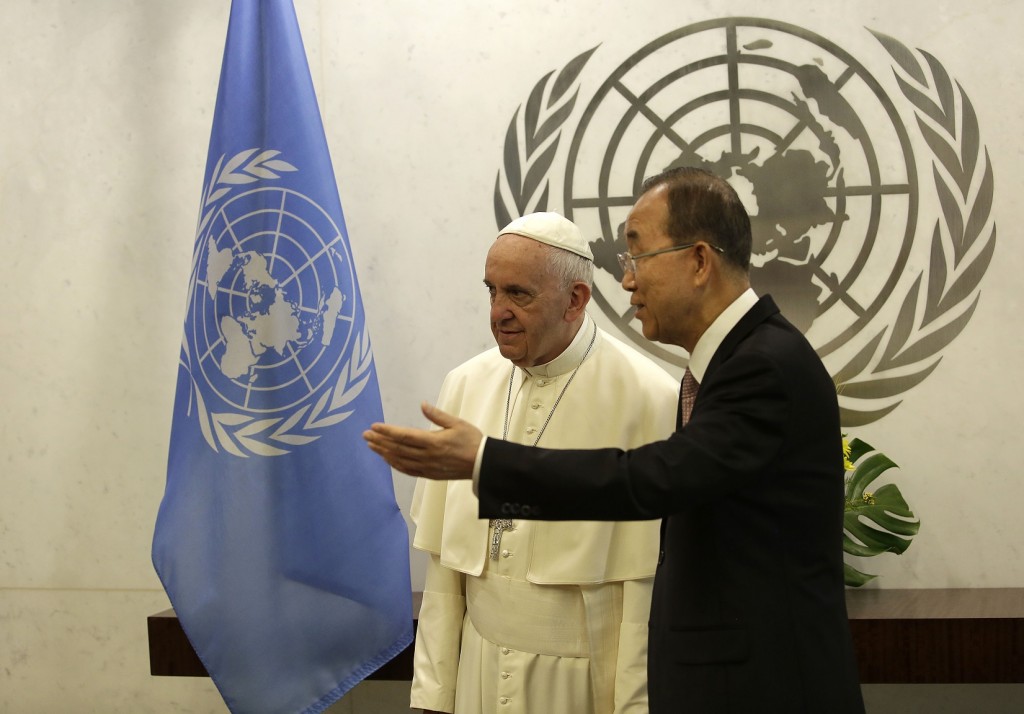 Pope Francis, left, talks with United Nations Secretary Ban Ki-moon at the United Nations headquarters, Friday, Sept. 25, 2015. (Joshua Lott/Pool Photo via AP)