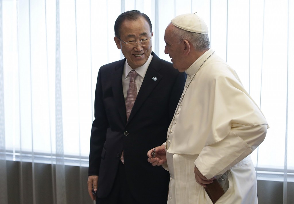 Pope Francis talks with United Nations Secretary Ban Ki-moon at the United Nations headquarters, Friday, Sept. 25, 2015. (Joshua Lott/Pool Photo via AP)