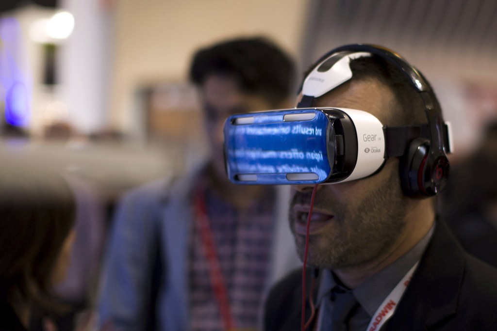 A visitor uses a Samsung virtual reality glasses during the Mobile World Congress Wireless show, the world's largest mobile phone trade show, in Barcelona, Spain, Tuesday, March 3, 2015. (AP Photo/Emilio Morenatti)