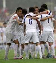 South Korea’s Kwon Chang-hoon, center, celebrates with his teammates scoring his side's third goal during the World Cup Group G qualification soccer match between Lebanon and South Korea in the southern port city of Sidon, Lebanon, Tuesday, Sept. 8, 2015. (AP Photo/Hassan Ammar)