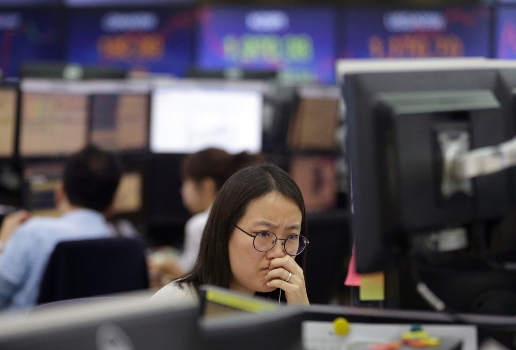 A currency trader watches monitors at the foreign exchange dealing room of the KEB Hana Bank headquarters in Seoul, South Korea, Friday, Sept. 18, 2015. Asian stocks were mostly higher Friday, perked by relief that the U.S. Federal Reserve held off on raising interest rates for the time being. (AP Photo/Ahn Young-joon)