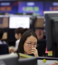 A currency trader watches monitors at the foreign exchange dealing room of the KEB Hana Bank headquarters in Seoul, South Korea, Friday, Sept. 18, 2015. Asian stocks were mostly higher Friday, perked by relief that the U.S. Federal Reserve held off on raising interest rates for the time being. (AP Photo/Ahn Young-joon)