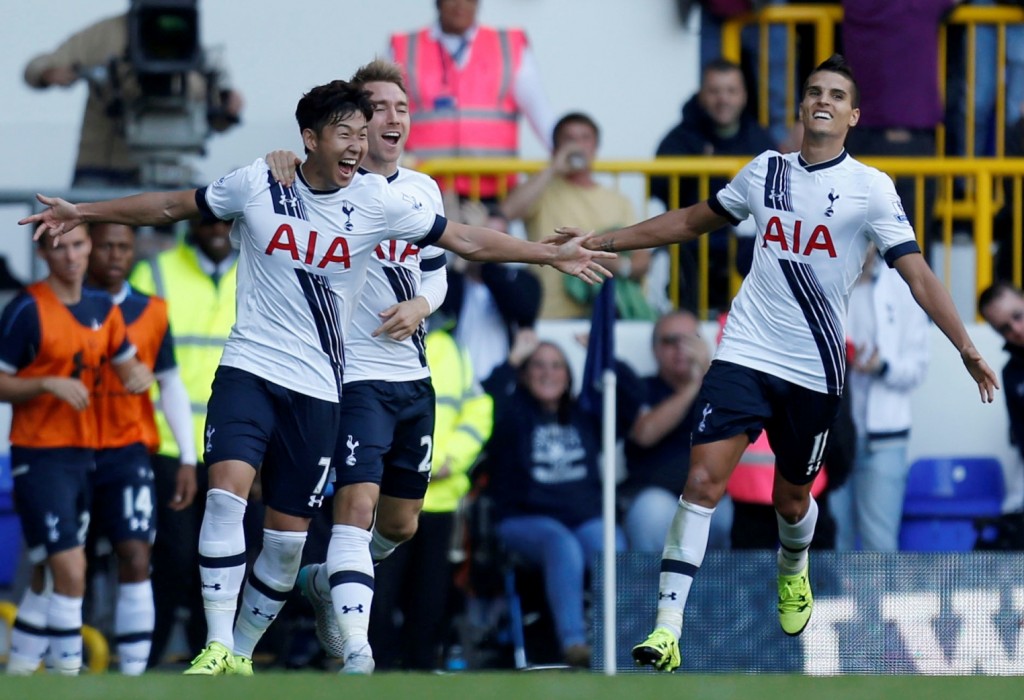 Tottenham Hotspur's Heung-Min Son, left, celebrates with Christian Eriksen and Erik Lamela, right, after scoring his side's first goal of the game against Crystal Palace during their English Premier League match at White Hart Lane, London, Sunday Sept. 20, 2015. (Paul Harding/PA via AP) 