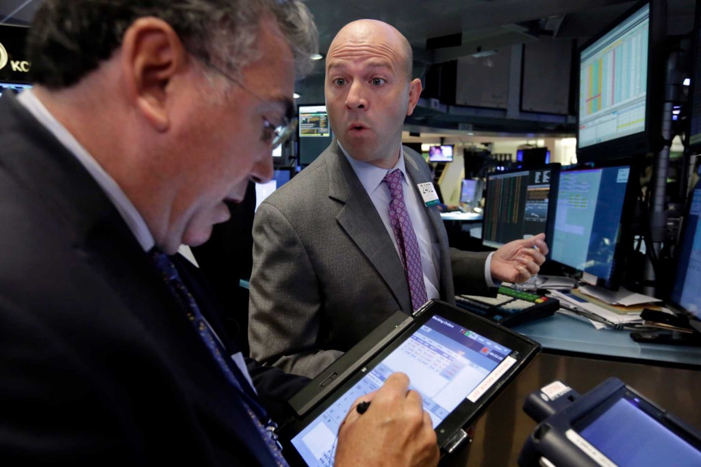 Specialist Jay Woods, right, works with trader John Bishop on the floor of the New York Stock Exchange, Wednesday, Sept. 2, 2015. U.S. and global stock markets were recovering in early morning trading Wednesday after a sharp sell-off a day earlier. Still, investors remain on edge after a plunge in stocks Tuesday that was triggered by reports showing slowing growth in China. (AP Photo/Richard Drew)