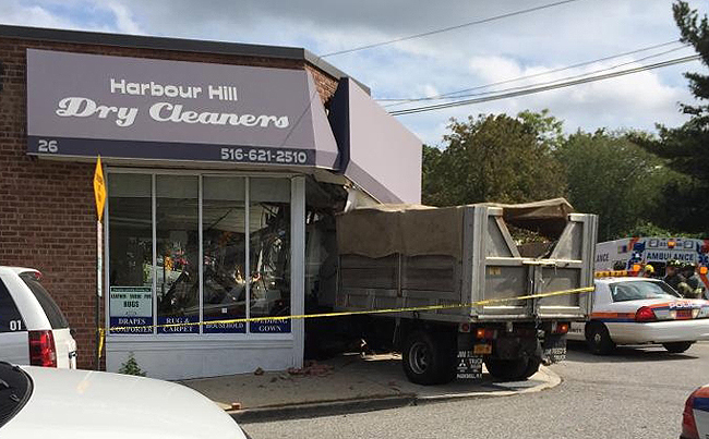 A dump truck crashed through the front doors of Harbour Hill Dry Cleaners in Long Island Tuesday.