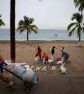 Residents prepare for the arrival of Hurricane Patricia filling sand bags to protect beachfront businesses, in Puerto Vallarta, Mexico, Friday, Oct. 23, 2015. Patricia barreled toward southwestern Mexico Friday as a monster Category 5 storm, the strongest ever in the Western Hemisphere. Locals and tourists were either hunkering down or trying to make last-minute escapes ahead of what forecasters called a "potentially catastrophic landfall" later in the day. (AP Photo/Rebecca Blackwell)