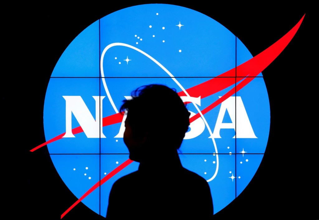 South Korean President Park Geun-hye walks past a NASA logo during a tour of projects and programs that are underway at the agency's Goddard Space Flight Center, Wednesday, Oct. 14, 2015, in Greenbelt, Md. (AP Photo/Patrick Semansky)