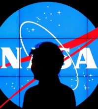 South Korean President Park Geun-hye walks past a NASA logo during a tour of projects and programs that are underway at the agency's Goddard Space Flight Center, Wednesday, Oct. 14, 2015, in Greenbelt, Md. (AP Photo/Patrick Semansky)