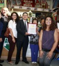 Los Angeles Police Department Captain Vito Palazzolo, third from left, State Senator Kevin de Leon staffer Ben Park, middle, deliver a commendation for outstanding public service to OK Liquor owner Lee Bong-ok Wednesday. (Park Sang-hyuk/Korea Times)