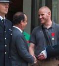 FILE - In this Aug. 24, 2015 file photo, French President Francois Hollande shakes hands with U.S. Airman Spencer Stone outside the Elysee Palace in Paris after Hollande awarded Stone and two friends with the French Legion of Honor for subduing a gunman on a Paris-bound train three days earlier. Stone is in stable condition Thursday, Oct. 8, 2015, after being stabbed in Sacramento, Calif., according to an Air Force spokesman. (AP Photo/Kamil Zihnioglu, File)