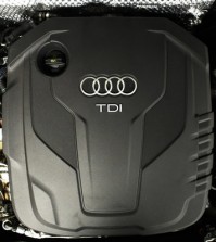 The sign of German car company Audi is attached on the engine of a TDI, a turbo diesel model, in Berlin, Germany, Monday, Sept. 28, 2015. Volkswagen AG's upmarket Audi brand said 2.1 million of its vehicles are among those with the engines affected by the emissions-rigging scandal. (AP Photo/Markus Schreiber)