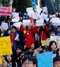 South Korean students hold signs during a rally demanding full compensation and apology for wartime sex slaves from Japanese government near the Japanese Embassy in Seoul, South Korea, Wednesday, Oct. 28, 2015. Only days before leaders from South Korea, Japan and China are to gather in Seoul this weekend, the event has still not yet been formally settled, with the South Korean and Japanese foreign ministries publicly dodging questions even as diplomats leak barbed tidbits to reporters behind the scenes. The problem this week, as is often the case in Northeast Asia, appears to be history, and specifically the inability of Seoul and Tokyo to settle disputes stemming from Japan’s brutal colonial rule of Korea in the early 20th century. The letters read "Apology and Live long and stay healthy." (AP Photo/Lee Jin-man)