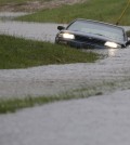 A car is submerged in floodwaters in Florence, S.C., Sunday, Oct. 4, 2015 after steady rain left many roads impassable, while flooding continues in many parts of the state. (AP Photo/Gerry Broome)