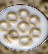 FILE - This June 15, 2011 file photo shows a spoonful of Honey Nut Cheerios in Pembroke, N.Y. General Mills on Monday, Oct. 5, 2015 said it is recalling 1.8 million boxes of Cheerios and Honey Nut Cheerios produced at a plant in Lodi, Calif., saying the cereal is labeled gluten-free but actually contains wheat. (AP Photo/David Duprey, File)