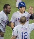 Texas Rangers, from left to right, Hanser Alberto, Choo Shin-soo, and Rougned Odor celebrate Choo scoring during the first inning in Game 2 of baseballs American League Division Series in Toronto on Friday, Oct. 9, 2015. (Darren Calabrese/The Canadian Press via AP)