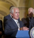 Senate Majority Leader Mitch McConnell, right, listens to Chairman of the Senate Foreign Relations Committee, Sen. Bob Corker, R-Tenn., center, speak to reporters. (AP Photo/Pablo Martinez Monsivais)