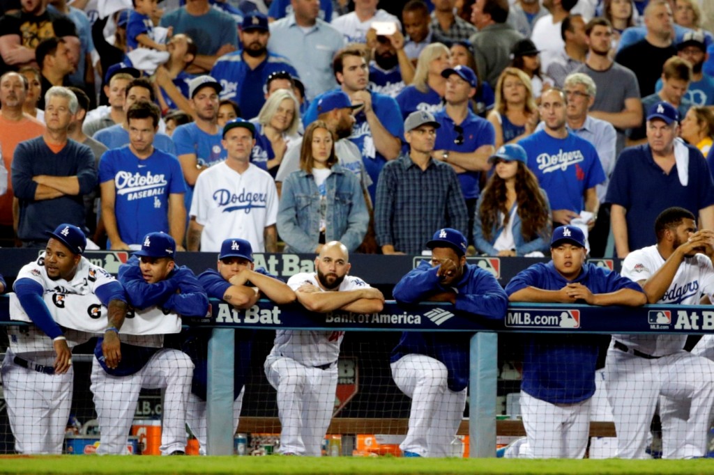 Los Angeles Dodgers watch from the dugout during the ninth inning against the New York Mets in Game 5 of baseball's National League Division Series Thursday, Oct. 15, 2015, in Los Angeles. The Mets won 3-2. (AP Photo/Lenny Ignelzi)