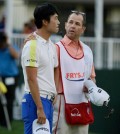 Kevin Na, left, talks with his caddie, Kenny Harms, right, on the 18th green of the Silverado Resort North Course after missing a par putt on the second playoff hole of the Frys.com golf tournament Sunday, Oct. 18, 2015, in Napa, Calif. (AP Photo/Eric Risberg)