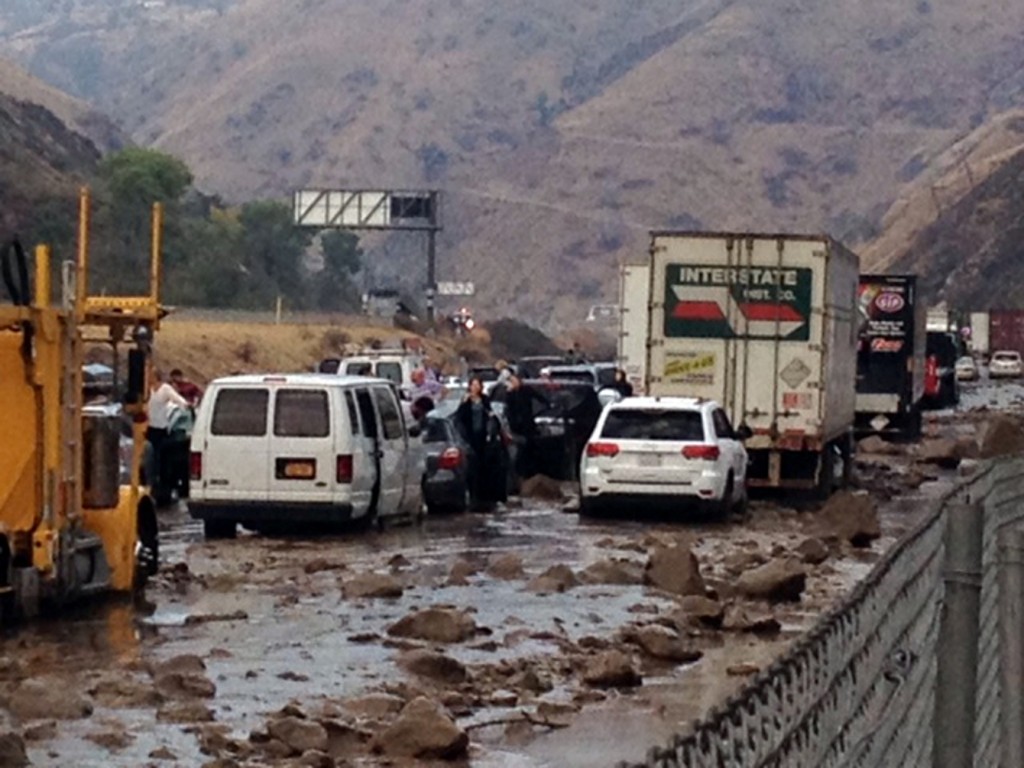 In this photo provided by Caltrans, vehicles are stopped in mud on California's Interstate-5 after flooding Thursday, Oct. 15, 2015. (Caltrans via AP)