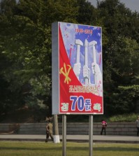 In this Sept. 15, 2015, photo, people walk past a sign board marking the upcoming 70th anniversary of the founding of North Korea's Workers' Party in Pyongyang, North Korea. While North Korea prepares a big show to mark the 70th anniversary of the ruling Workersâ€™ Party, the daily struggles of life outside the capital - such as finding clean running water and putting nutritious food on the table year-round - pose a harsh, but largely unseen, contrast to the grand celebrations the world will see Oct. 10. (AP Photo/Wong Maye-E)