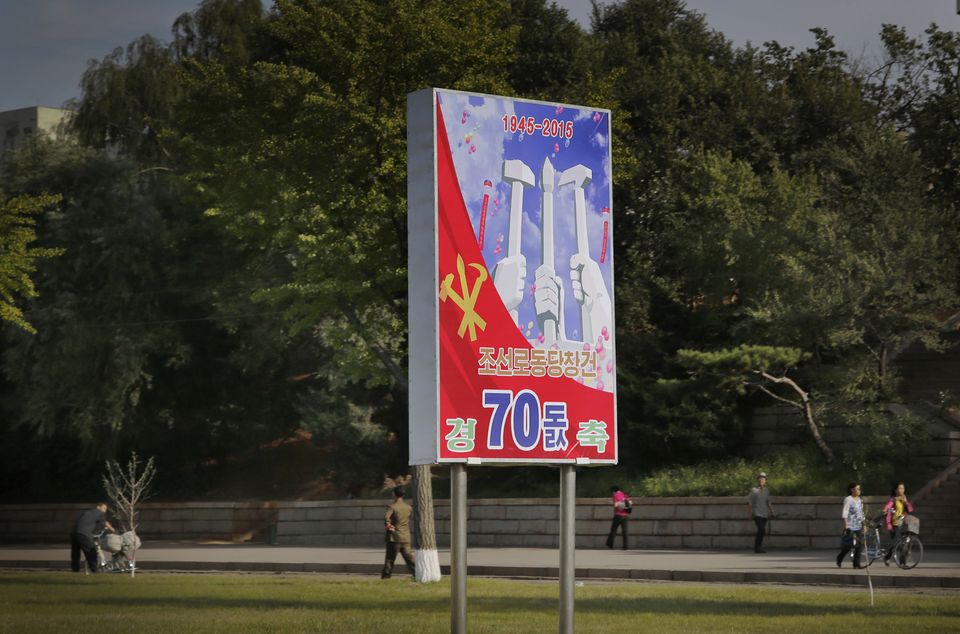 In this Sept. 15, 2015, photo, people walk past a sign board marking the upcoming 70th anniversary of the founding of North Korea's Workers' Party in Pyongyang, North Korea. While North Korea prepares a big show to mark the 70th anniversary of the ruling Workersâ€™ Party, the daily struggles of life outside the capital - such as finding clean running water and putting nutritious food on the table year-round - pose a harsh, but largely unseen, contrast to the grand celebrations the world will see Oct. 10. (AP Photo/Wong Maye-E)