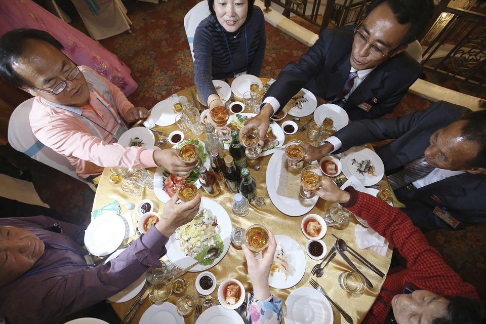 North Korean Kim Chang Ho, 87, second from right, toasts with his South Korean family members at a luncheon during the Separated Family Reunion Meeting at Diamond Mountain resort in North Korea, Wednesday, Oct. 21, 2015. Hundreds of elderly Koreans from divided North and South began three days of reunions Tuesday with loved ones many have had no contact with since the war between the countries more than 60 years ago. (Kim Do-hoon/Yonhap via AP)