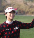 Park Sung-hyun of South Korea acknowledges spectators after sinking a birdie putt on the 18th green during the first round of the KEB Hana Bank Championship golf tournament at Sky72 Golf Club in Incheon, South Korea, Thursday, Oct. 15, 2015. (AP Photo/Ahn Young-joon)