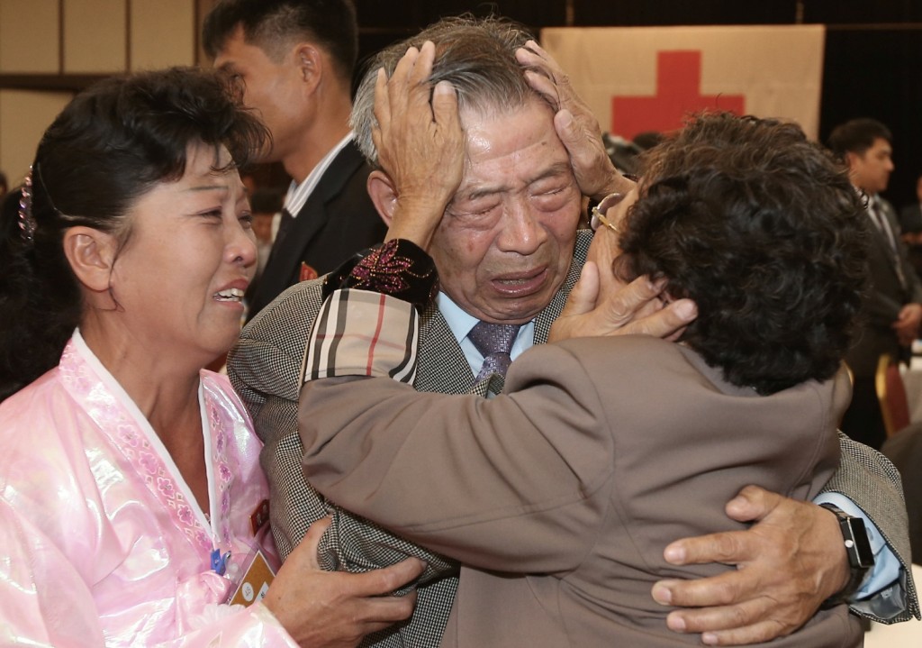 South Korean Min Ho-shik, 84, center, hugs his North Korean family member Min Un Sik, right, during the Separated Family Reunion Meeting at Diamond Mountain resort in North Korea, Tuesday, Oct. 20, 2015. Hundreds of elderly Koreans from divided North and South began three days of reunions Tuesday with loved ones many have had no contact with since the war between the countries more than 60 years ago. At left is an unidentified family member of North Korean Min.(Kim Do-hoon/Yonhap via AP) 