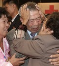 South Korean Min Ho-shik, 84, center, hugs his North Korean family member Min Un Sik, right, during the Separated Family Reunion Meeting at Diamond Mountain resort in North Korea, Tuesday, Oct. 20, 2015. Hundreds of elderly Koreans from divided North and South began three days of reunions Tuesday with loved ones many have had no contact with since the war between the countries more than 60 years ago. At left is an unidentified family member of North Korean Min.(Kim Do-hoon/Yonhap via AP)