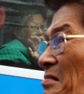 Jung Gun-mok, front, a 64-year-old former South Korean fisherman who was abducted by North Korea in the Yellow Sea about 40 years ago, looks away as he is about to burst into tears, as he bids farewell to his mother on the bus. His mother Lee Bok-soon, 88, helplessly looks out the window as the bus is about to leave the resort on Mount Kumgang on the North's east coast on Oct. 26, 2015, the last day of the three-day reunions.  (Yonhap)