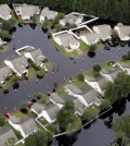 This aerial photo show flooding around homes in the Carolina Forest community in Horry County, between Conway and Myrtle Beach, S.C. The Carolinas saw sunshine Tuesday after days of inundation, but it could take weeks to recover from being pummeled by a historic rainstorm that caused widespread flooding and multiple deaths. (Janet Blackmon Morgan/The Sun News via AP)