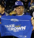 Kansas City Royals fan Lee Sung-woo, from South Korea, shows off a World Series towel before Game 1 of baseball's World Series between the Kansas City Royals and the San Francisco Giants Tuesday, Oct. 21, 2014, in Kansas City, Mo. (AP Photo/Charlie Neibergall)