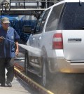 In this June 24, 2015, file photo, a worker washes a car at Bob's Car Wash in Roseville, Calif. To reduce water use, owner Nancy van Overbeek says the facility had upgraded its recycling and reclamation system and was not watering its lawn. State officials plan to tell Californians what penalties they are taking against communities that fail to meet a mandated 25 percent reduction in water use when they announce usage figures Friday, Oct. 30, in the state’s battle against a widespread drought. (AP Photo/Rich Pedroncelli, File)
