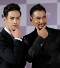 Hong Kong actor Simon Yam, right, and South Korean actor Han Ji-seok pose as they arrive to attend the opening ceremony of the Busan International Film Festival at Busan Cinema Center in Busan, South Korea, Thursday, Oct. 1, 2015. (AP Photo/Ahn Young-joon)