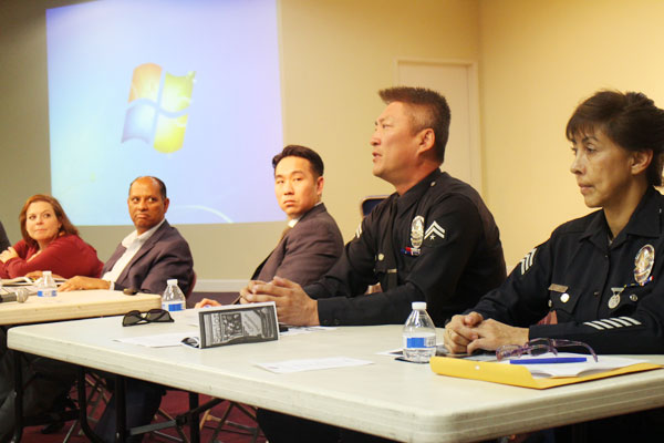 LAPD Officer Henry Choi, second from right, speaks during a seminar on elder abuse Saturday inside a Korean church. 