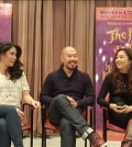 Hoon Lee, center, sits with co-stars Ashley Park, right, and Ruthie Ann Miles.