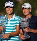 Lydia Ko, left, and Cristie Kerr hold their trophies at the conclusion of the CME Group Tour Championship golf tournament on Sunday, Nov. 22, 2015, in Naples, Fla. (David Albers/Naples Daily News via AP)